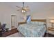 Comfortable bedroom with hardwood floors, fan, window with blinds, and relaxing decor at 6232 Crickethollow Dr, Riverview, FL 33578