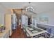 Bright dining room featuring hardwood floors, modern light fixture, seating for six, and views into other rooms at 6232 Crickethollow Dr, Riverview, FL 33578