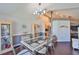 Bright dining room featuring hardwood floors, modern light fixture, seating for six, and views into other rooms at 6232 Crickethollow Dr, Riverview, FL 33578