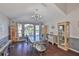 Elegant dining room featuring dark hardwood floors, ample natural light, and stylish furnishings at 6232 Crickethollow Dr, Riverview, FL 33578