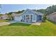 Charming single-story blue home with well-kept lawn, manicured shrubbery, and beautiful accents at 6232 Crickethollow Dr, Riverview, FL 33578