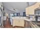 Bright kitchen featuring modern appliances, cabinetry, and an open view to the adjacent living area at 6232 Crickethollow Dr, Riverview, FL 33578