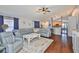 Inviting living room with modern blue leather furniture and hardwood floors at 6232 Crickethollow Dr, Riverview, FL 33578
