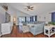 Open living room featuring hardwood floors, high ceilings, and sliding glass doors to the outdoor patio at 6232 Crickethollow Dr, Riverview, FL 33578
