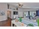 Spacious living room featuring hardwood floors, a wall-mounted TV, and sliding glass doors to the patio at 6232 Crickethollow Dr, Riverview, FL 33578