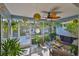 Cozy screened-in porch with comfortable seating, plants, and a ceiling fan for relaxing outdoors at 6232 Crickethollow Dr, Riverview, FL 33578