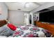 Spacious bedroom featuring a patchwork quilt, ceiling fan, and access to an attached bathroom at 702 Regent S Cir, Brandon, FL 33511