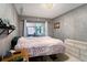 Bedroom featuring tile floors, slider to Florida room, and modern lighting at 702 Regent S Cir, Brandon, FL 33511