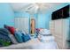 Bedroom featuring light blue walls, closet with sliding doors, and tiled floors at 702 Regent S Cir, Brandon, FL 33511