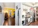 Hallway with wood floors leading to the kitchen with stainless steel appliances and ample counter space at 702 Regent S Cir, Brandon, FL 33511