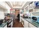 Galley kitchen with stainless steel appliances, dark wood floors, and plenty of cabinet space at 702 Regent S Cir, Brandon, FL 33511