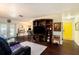 Bright living room featuring hardwood floors, a large entertainment center, and a cheerful yellow door at 702 Regent S Cir, Brandon, FL 33511