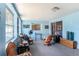Bright living room featuring light blue walls and multiple windows to let in the light at 702 Regent S Cir, Brandon, FL 33511