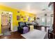 Spacious living room featuring stylish furniture, wood floors, and a bright yellow accent wall for a vibrant touch at 702 Regent S Cir, Brandon, FL 33511