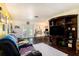 Open living room with wood floors, large entertainment center, and natural light streaming through the glass doors at 702 Regent S Cir, Brandon, FL 33511