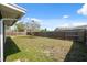 Large, grassy backyard surrounded by a wooden privacy fence at 7123 Cherry Laurel Dr, Port Richey, FL 34668