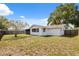 Backyard featuring a white home with a screened in porch and privacy fence at 7123 Cherry Laurel Dr, Port Richey, FL 34668