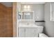Bathroom featuring a walk-in shower, a dual-flush toilet, and vanity with a framed mirror at 7123 Cherry Laurel Dr, Port Richey, FL 34668