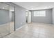A bedroom with two mirrored closet doors, and tiled flooring at 7123 Cherry Laurel Dr, Port Richey, FL 34668
