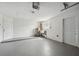 Spacious garage with white walls, utility sink and white door at 7123 Cherry Laurel Dr, Port Richey, FL 34668