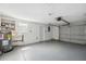 Spacious garage featuring a water heater, utility sink and garage door at 7123 Cherry Laurel Dr, Port Richey, FL 34668