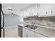 This kitchen has granite countertops, stainless steel appliances, and tile backsplash at 7123 Cherry Laurel Dr, Port Richey, FL 34668