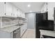 This kitchen features white cabinets, granite countertops, and stainless steel appliances at 7123 Cherry Laurel Dr, Port Richey, FL 34668