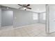 A living room with tile floors, ceiling fan, and two windows at 7123 Cherry Laurel Dr, Port Richey, FL 34668