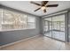 Living room featuring neutral wall color, a ceiling fan, and access to a screened patio at 7123 Cherry Laurel Dr, Port Richey, FL 34668