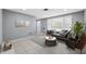 Bright living room with neutral walls, large windows for ample natural light, and tile flooring at 7123 Cherry Laurel Dr, Port Richey, FL 34668