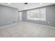 Bright living room with neutral walls, tile floors, and a large window for abundant natural light at 7123 Cherry Laurel Dr, Port Richey, FL 34668