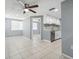 Open living space showcasing tile floors, neutral walls, and seamless flow into the kitchen area at 7123 Cherry Laurel Dr, Port Richey, FL 34668