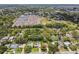 An aerial view of a residential neighborhood, showcasing a school bus depot, mature trees, and landscaping at 734 Lake Forest Rd, Clearwater, FL 33765