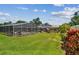Expansive backyard showcasing a screened-in pool area, a covered patio, and beautiful landscaping at 734 Lake Forest Rd, Clearwater, FL 33765