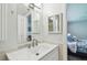 Modern bathroom featuring a white vanity, tile accents and a mirror reflecting shower at 734 Lake Forest Rd, Clearwater, FL 33765