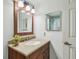 Bathroom featuring a vanity with a faux marble countertop and a framed mirror above the sink at 734 Lake Forest Rd, Clearwater, FL 33765