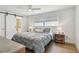 Cozy bedroom with wood floors, neutral walls, and a barn door to bathroom at 734 Lake Forest Rd, Clearwater, FL 33765