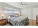 Well-lit bedroom featuring wood floors, a ceiling fan, and a serene ambiance at 734 Lake Forest Rd, Clearwater, FL 33765