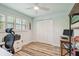 Bright bedroom with a work space, closet, and a window with plantation shutters at 734 Lake Forest Rd, Clearwater, FL 33765