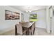 Bright dining room featuring tile floors, modern lighting, and a rustic table at 734 Lake Forest Rd, Clearwater, FL 33765
