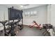 Home gym equipped with modern exercise equipment and a large flat-screen TV for an immersive workout at 734 Lake Forest Rd, Clearwater, FL 33765