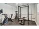 Well-equipped home gym with exercise bike, weight rack, and bench press for a complete workout experience at 734 Lake Forest Rd, Clearwater, FL 33765