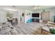 Spacious living room with open layout, tile floors, and seamless flow to the dining area at 734 Lake Forest Rd, Clearwater, FL 33765