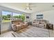 Inviting living room showcasing neutral tones, tile flooring and abundant natural light at 734 Lake Forest Rd, Clearwater, FL 33765