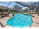 A large backyard pool is surrounded by landscaping and outdoor seating at 734 Lake Forest Rd, Clearwater, FL 33765