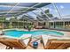 Inviting screened-in pool area with comfortable lounge chairs perfect for relaxing or entertaining guests at 734 Lake Forest Rd, Clearwater, FL 33765