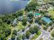 Aerial view of luxurious community amenities, including a pool, tennis court, and lake access at 7410 Ambleside Dr, Land O Lakes, FL 34637