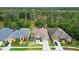 Aerial view of a single Gathering home with a well-manicured lawn in a lush residential community at 7410 Ambleside Dr, Land O Lakes, FL 34637