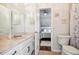 Bathroom featuring vanity with sink, toilet, and view of a serene bedroom at 7410 Ambleside Dr, Land O Lakes, FL 34637