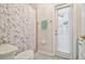 Bathroom with toilet and shower with curtain. Access to backyard from door at 7410 Ambleside Dr, Land O Lakes, FL 34637